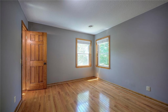 1906 Blackbird Cir, Kearney, MO 64060 - spare room with hardwood / wood-style flooring and a textured ceiling