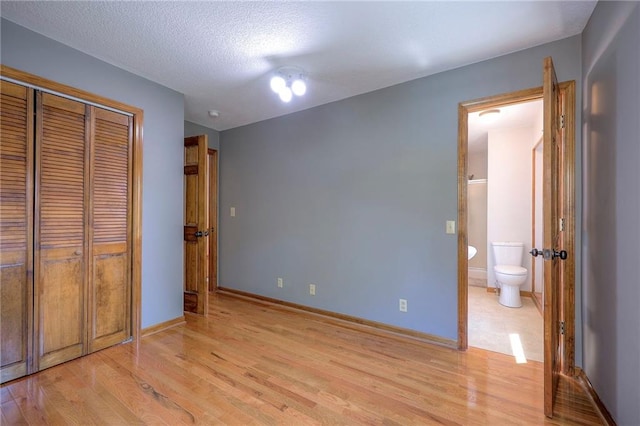 1906 Blackbird Cir, Kearney, MO 64060 - unfurnished bedroom with light wood-style floors, a closet, and connected bathroom