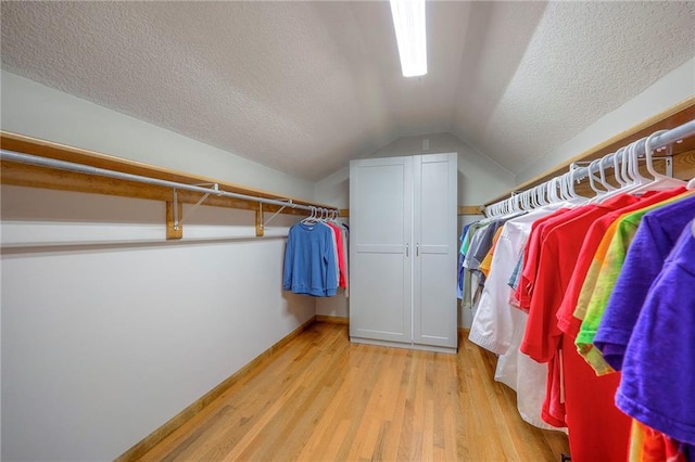 1906 Blackbird Cir, Kearney, MO 64060 - walk in closet featuring light wood-type flooring and lofted ceiling