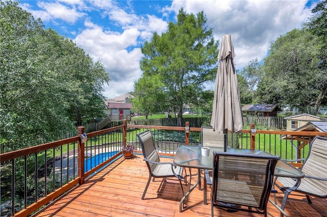 1906 Blackbird Cir, Kearney, MO 64060 - wooden deck with outdoor dining area and a fenced backyard