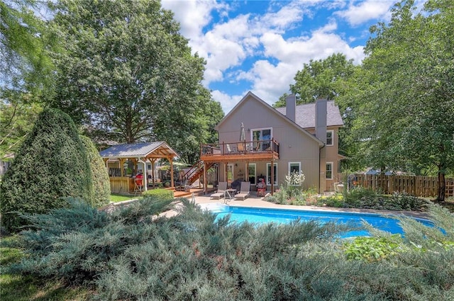 1906 Blackbird Cir, Kearney, MO 64060 - rear view of property with stairway, a wooden deck, a chimney, and a patio