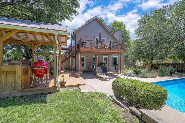 1906 Blackbird Cir, Kearney, MO 64060 - rear view of house featuring a deck, a fenced backyard, a patio area, and a metal roof