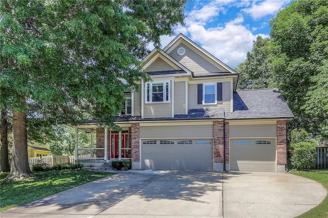 1906 Blackbird Cir, Kearney, MO 64060 - craftsman-style home featuring driveway, a porch, brick siding, and a garage