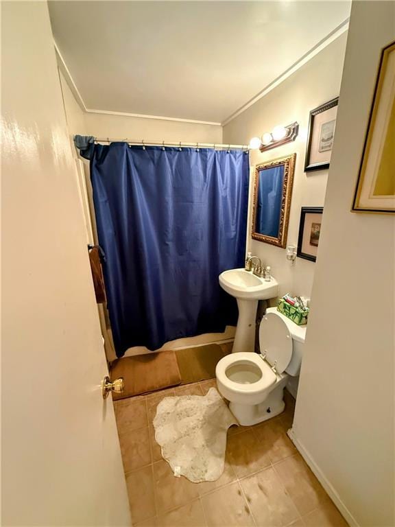 2317 Englewood Ct, Independence, MO 64052 - bathroom with toilet, tile patterned floors, crown molding, and shower / bath combo