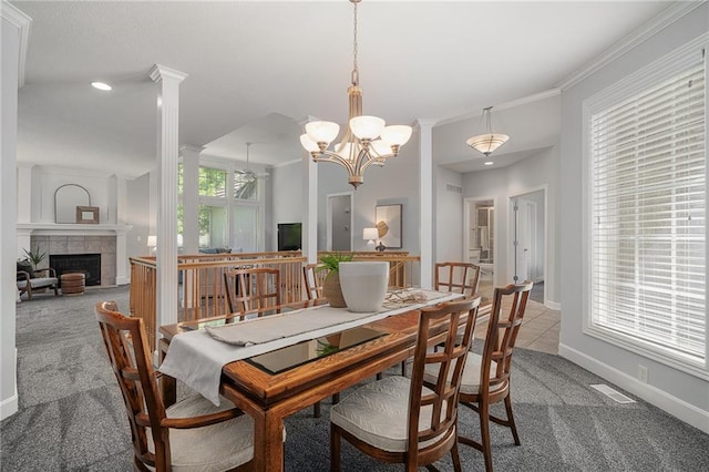 14393 S Cody St, Olathe, KS 66062 - dining area with decorative columns, carpet, baseboards, a tile fireplace, and ornamental molding