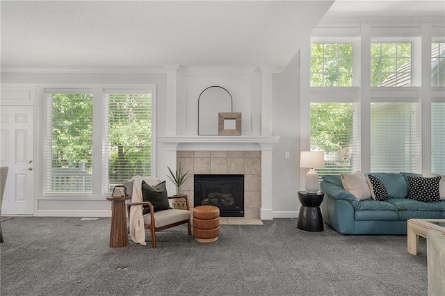 14393 S Cody St, Olathe, KS 66062 - living room with carpet floors, a tiled fireplace, baseboards, and crown molding