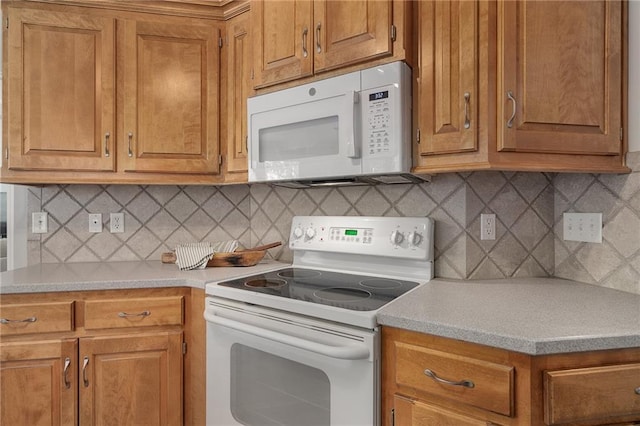 14393 S Cody St, Olathe, KS 66062 - kitchen with white appliances, light countertops, and brown cabinetry