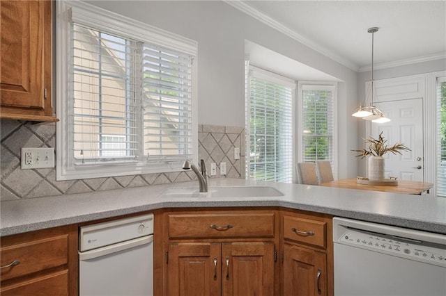 14393 S Cody St, Olathe, KS 66062 - kitchen with white dishwasher, a sink, brown cabinets, backsplash, and crown molding