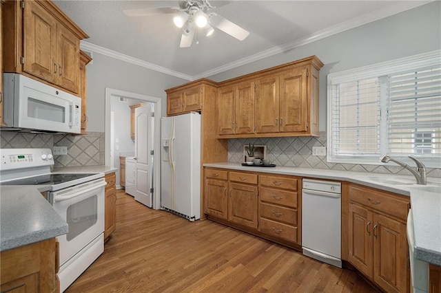 14393 S Cody St, Olathe, KS 66062 - kitchen featuring white appliances, light wood-style flooring, crown molding, a ceiling fan, and decorative backsplash