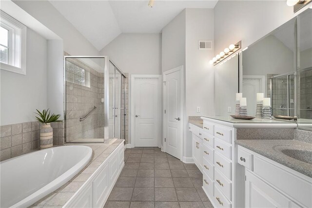 14393 S Cody St, Olathe, KS 66062 - bathroom with vanity, a shower stall, lofted ceiling, a bath, and tile patterned flooring