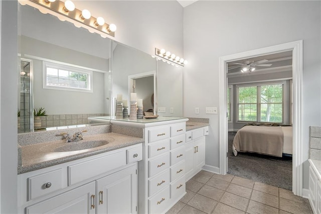 14393 S Cody St, Olathe, KS 66062 - ensuite bathroom featuring double vanity, plenty of natural light, tile patterned flooring, and baseboards