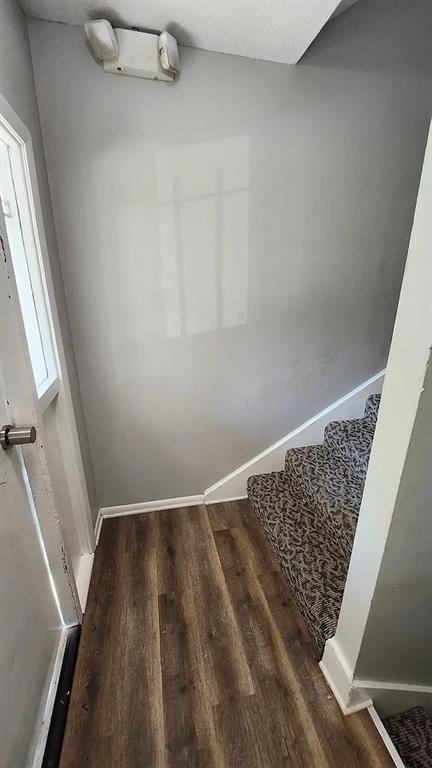 6126 Farrow Ave, Kansas City, KS 66104 - stairs with wood finished floors and baseboards