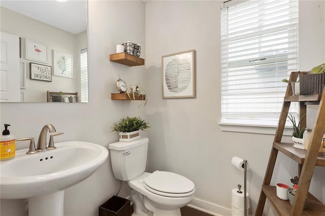 1405 Newport Ln, Raymore, MO 64083 - half bath featuring a sink, plenty of natural light, and toilet