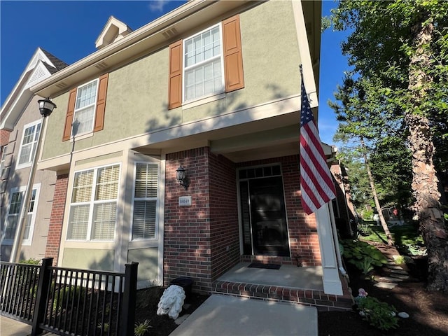 16049 S Brookfield St, Olathe, KS 66062 - view of front of home with brick siding, a porch, and stucco siding
