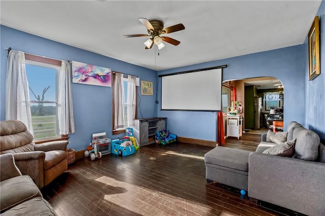 1332 Clark Rd, Williamsburg, KS 66095 - home theater room featuring a ceiling fan, arched walkways, and hardwood / wood-style flooring