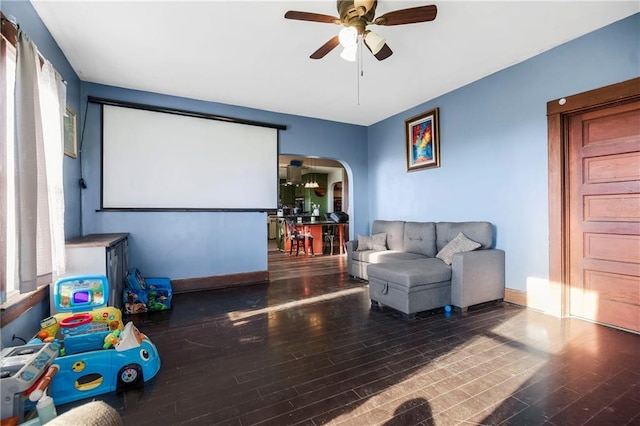 1332 Clark Rd, Williamsburg, KS 66095 - home theater featuring ceiling fan, wood-type flooring, arched walkways, and baseboards