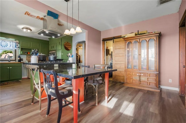 1332 Clark Rd, Williamsburg, KS 66095 - dining area featuring arched walkways, wood finished floors, and baseboards