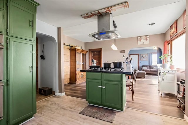 1332 Clark Rd, Williamsburg, KS 66095 - kitchen with green cabinetry, arched walkways, and island exhaust hood