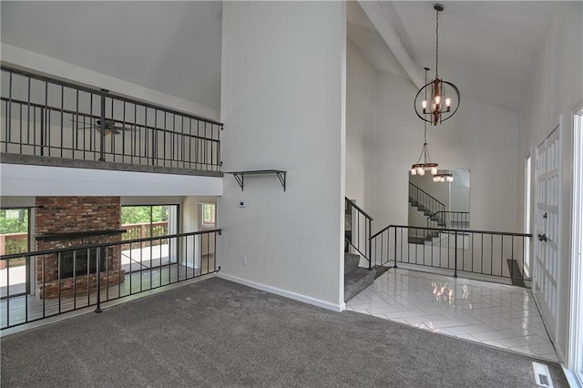 3512 Apple Tree Ln, Gladstone, MO 64119 - unfurnished living room with high vaulted ceiling, stairway, a chandelier, healthy amount of natural light, and baseboards