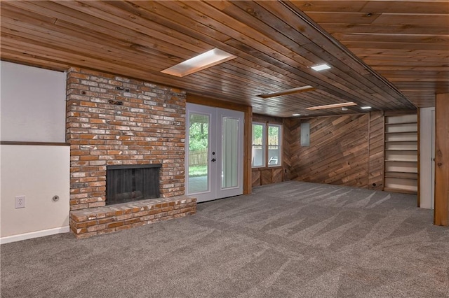 3512 Apple Tree Ln, Gladstone, MO 64119 - unfurnished living room with wood ceiling, a fireplace, carpet, and wood walls