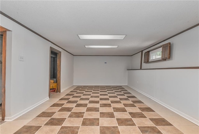 3512 Apple Tree Ln, Gladstone, MO 64119 - below grade area with tile patterned floors, ornamental molding, a textured ceiling, and baseboards