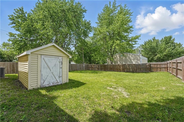 view of yard with a storage shed, central AC unit, and an outdoor structure