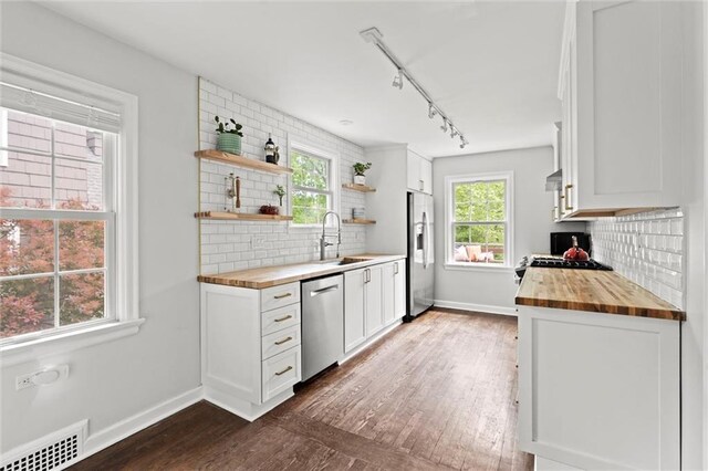 6843 Locust St, Kansas City, MO 64131 - kitchen with butcher block counters, stainless steel appliances, a sink, and open shelves