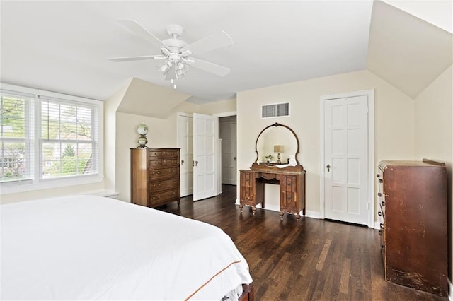 6843 Locust St, Kansas City, MO 64131 - bedroom with dark wood finished floors, lofted ceiling, a ceiling fan, baseboards, and two closets