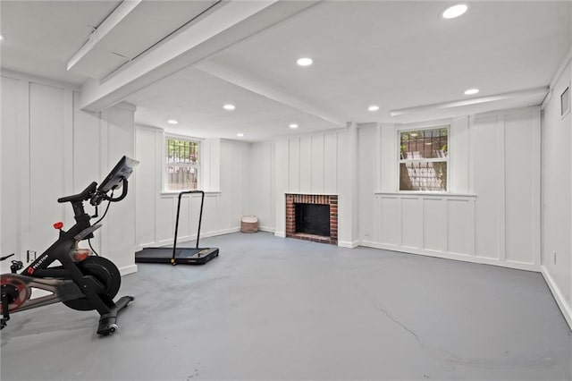 6843 Locust St, Kansas City, MO 64131 - workout room featuring a fireplace, recessed lighting, a decorative wall, and baseboards