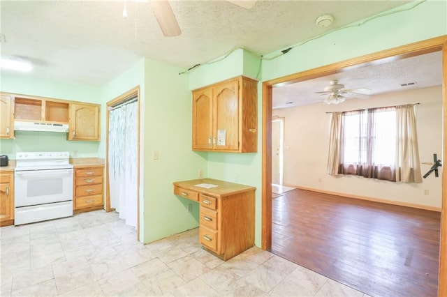 1175 SW State Route 58th Hwy, Holden, MO 64040 - kitchen featuring white electric range oven, under cabinet range hood, a ceiling fan, a textured ceiling, and light countertops
