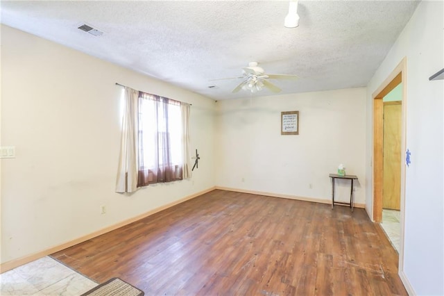 1175 SW State Route 58th Hwy, Holden, MO 64040 - unfurnished room featuring wood finished floors, a textured ceiling, a ceiling fan, and baseboards