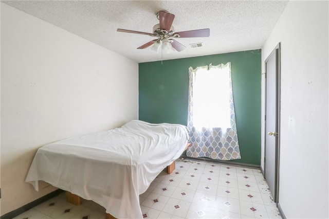 1175 SW State Route 58th Hwy, Holden, MO 64040 - bedroom with a textured ceiling, ceiling fan, light floors, and baseboards