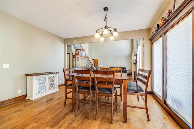 4000 S Buckner Tarsney Rd, Grain Valley, MO 64029 - dining room with light wood-type flooring, baseboards, and a chandelier