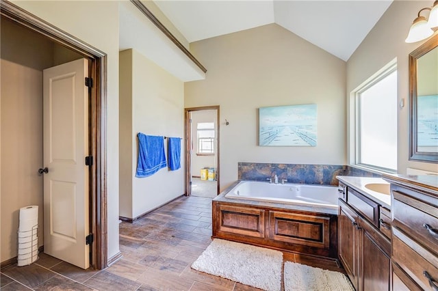 4000 S Buckner Tarsney Rd, Grain Valley, MO 64029 - full bathroom featuring a garden tub, vanity, and lofted ceiling