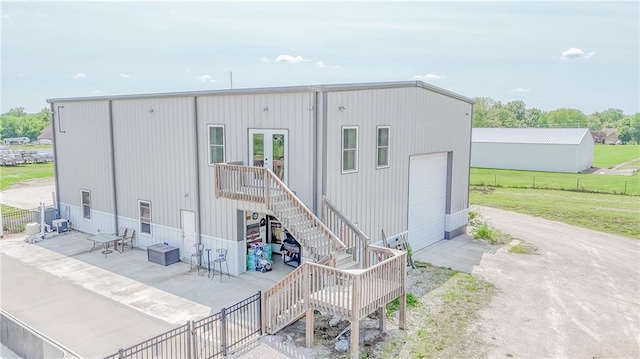 4000 S Buckner Tarsney Rd, Grain Valley, MO 64029 - rear view of house featuring stairway and a patio
