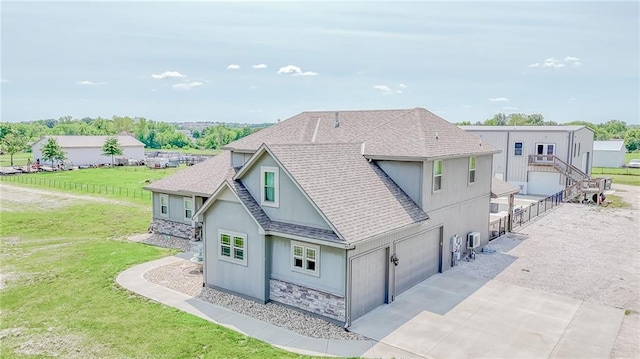 4000 S Buckner Tarsney Rd, Grain Valley, MO 64029 - view of front facade featuring a shingled roof, stone siding, stucco siding, and driveway