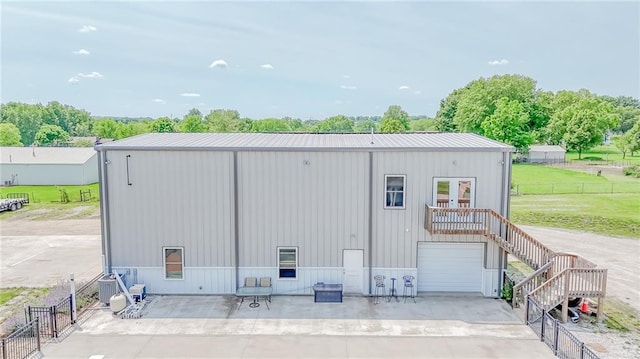 4000 S Buckner Tarsney Rd, Grain Valley, MO 64029 - view of outbuilding with stairs, a garage, and central AC