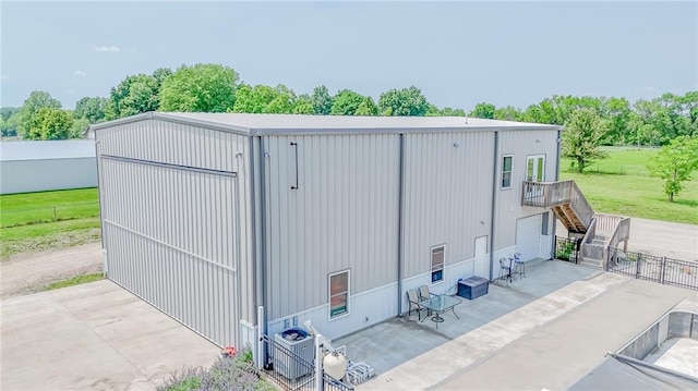 4000 S Buckner Tarsney Rd, Grain Valley, MO 64029 - view of outdoor structure with stairway, view of wooded area, and a garage