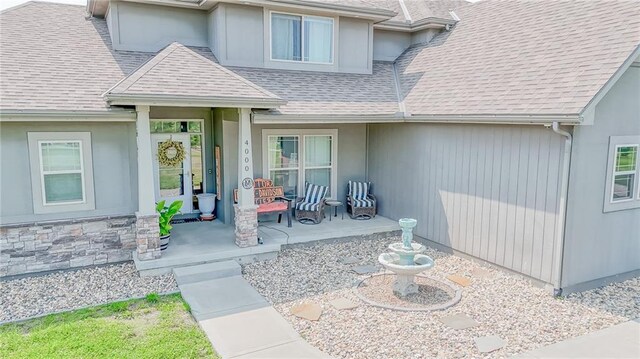 4000 S Buckner Tarsney Rd, Grain Valley, MO 64029 - view of exterior entry with covered porch and a shingled roof