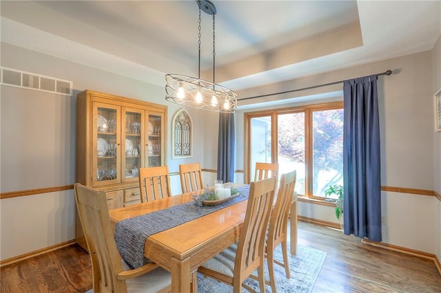 1407 SW Meyer Blvd, Blue Springs, MO 64015 - dining area featuring wood finished floors, baseboards, and a tray ceiling