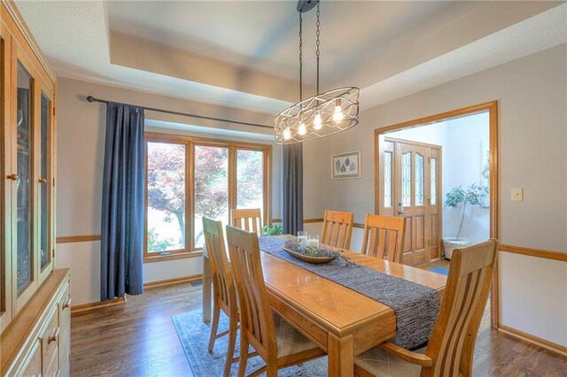 1407 SW Meyer Blvd, Blue Springs, MO 64015 - dining room with baseboards, wood finished floors, and a raised ceiling