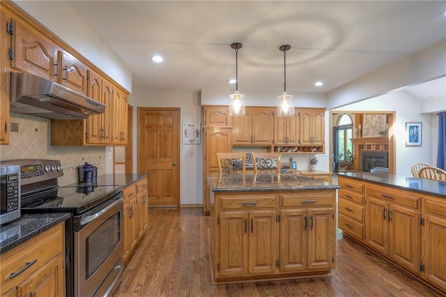 1407 SW Meyer Blvd, Blue Springs, MO 64015 - kitchen featuring appliances with stainless steel finishes, under cabinet range hood, a kitchen island, dark wood finished floors, and recessed lighting