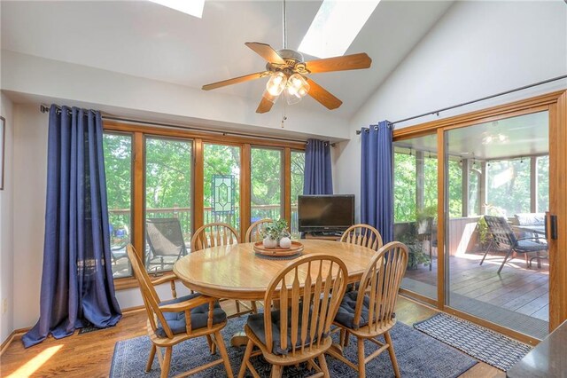 1407 SW Meyer Blvd, Blue Springs, MO 64015 - dining area with wood finished floors, ceiling fan, a skylight, and high vaulted ceiling