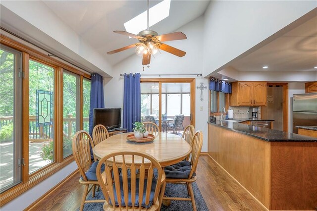 1407 SW Meyer Blvd, Blue Springs, MO 64015 - dining room with wood finished floors, lofted ceiling, a ceiling fan, a skylight, and recessed lighting