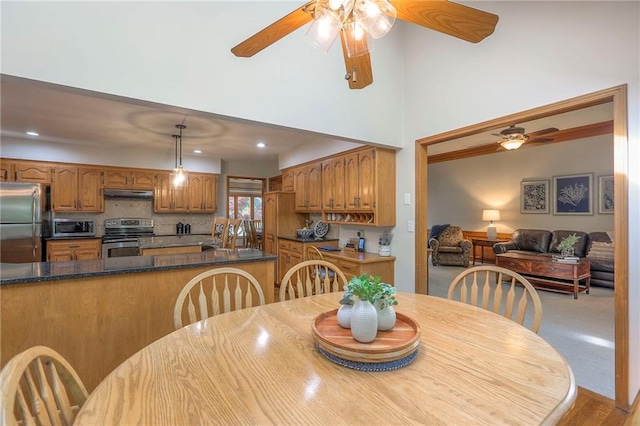 1407 SW Meyer Blvd, Blue Springs, MO 64015 - dining area with a ceiling fan, recessed lighting, and a towering ceiling
