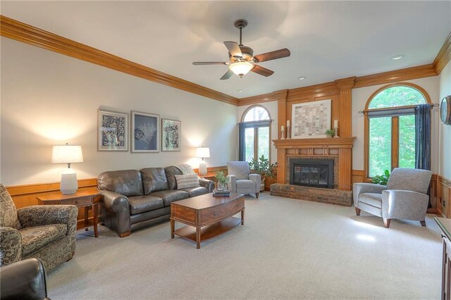 1407 SW Meyer Blvd, Blue Springs, MO 64015 - living room with carpet floors, crown molding, ceiling fan, a fireplace, and wainscoting