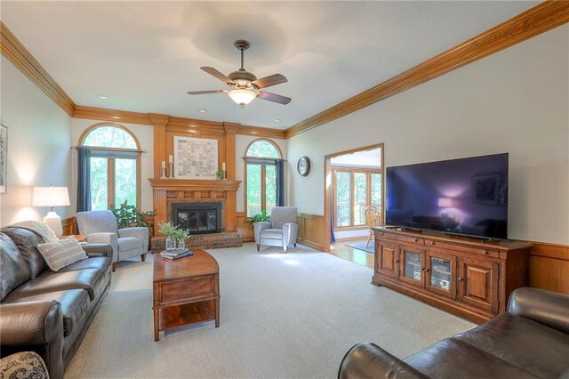 1407 SW Meyer Blvd, Blue Springs, MO 64015 - carpeted living room with ornamental molding, ceiling fan, plenty of natural light, a fireplace, and wainscoting