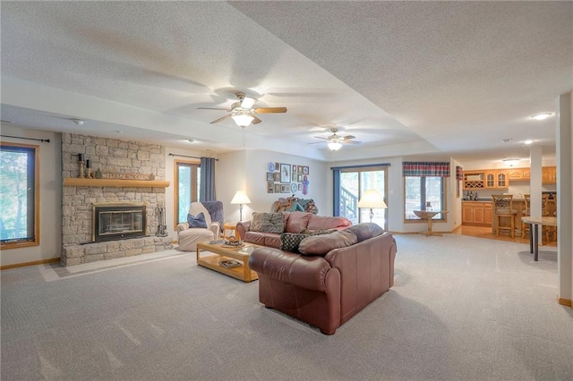 1407 SW Meyer Blvd, Blue Springs, MO 64015 - carpeted living area with a textured ceiling, plenty of natural light, a fireplace, and a ceiling fan