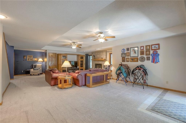 1407 SW Meyer Blvd, Blue Springs, MO 64015 - living room with baseboards, light carpet, ceiling fan, a large fireplace, and a textured ceiling