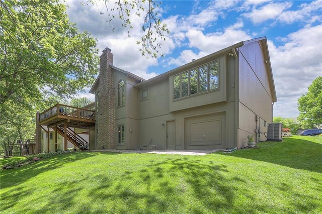 1407 SW Meyer Blvd, Blue Springs, MO 64015 - rear view of house with stairs, a chimney, central air condition unit, a wooden deck, and a garage